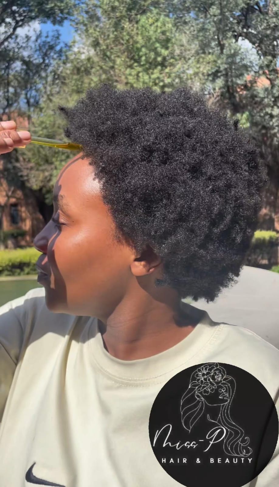 Model holding MISSP Hair Growth Oil product